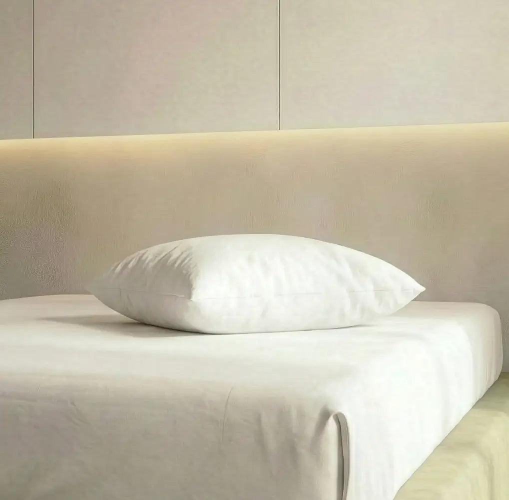 weißes Kopfkissen in einem hellen Schlafzimmer